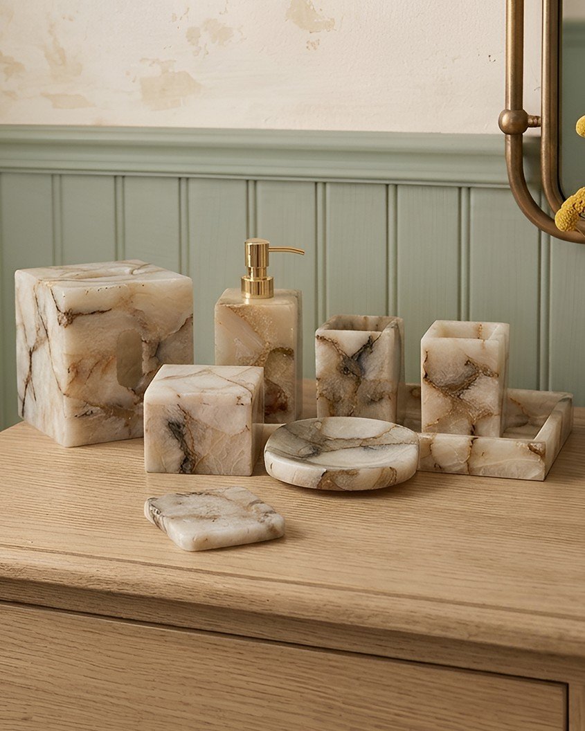 Marble soap dispenser, tumbler and tray on a stone vanity
